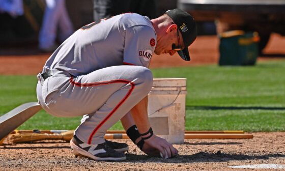 [Fajardo] San Francisco Giants' Mark Canha scoops up dirt from home plate after their MLB game at the Coliseum in Oakland, Calif., on Aug. 18, 2024. The San Francisco Giants defeated the Oakland Athletics 4-2 in 10 innings. This is the Giants last game at the Coliseum after this season.