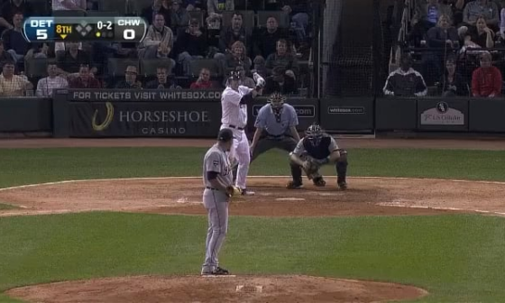 Foul ball off catchers mask creates sparks.