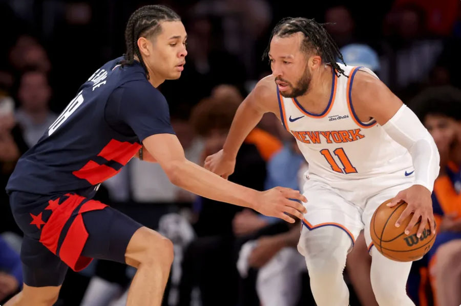 Nov 18, 2024; New York, New York, USA; New York Knicks guard Jalen Brunson (11) controls the ball against Washington Wizards forward Kyshawn George (18) during the second quarter at Madison Square Garden. Mandatory Credit: Brad Penner-Imagn Images