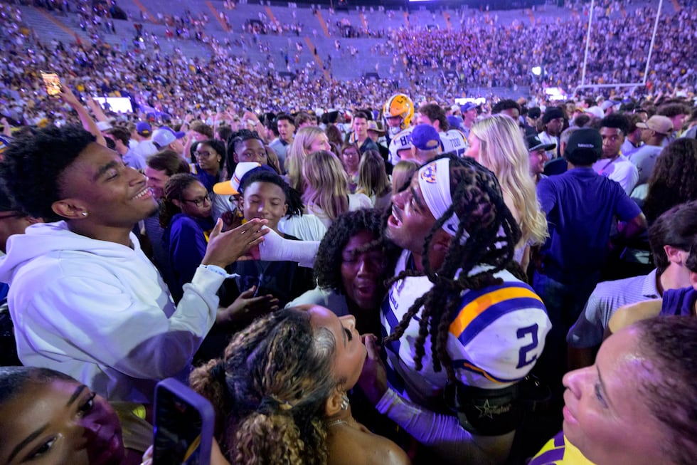 LSU safety Jardin Gilbert (2) celebrates with LSU fans after they rushed the field after the...