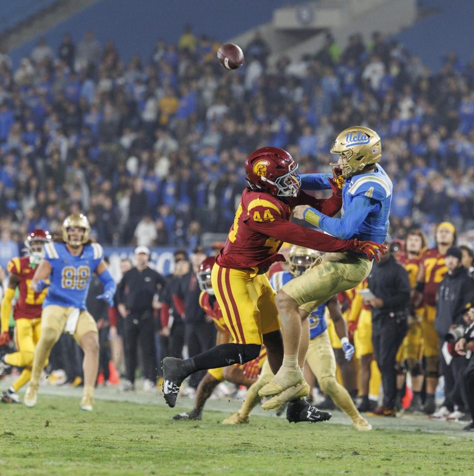 USC defensive end Sam Greene pressures and tackles UCLA quarterback Ethan Garbers on fourth down.