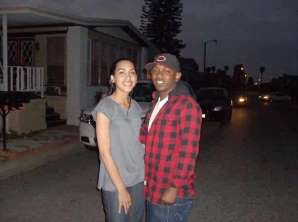 Kendrick Lamar wearing a Reds hat