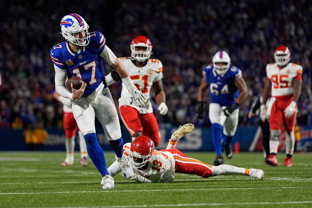  Bills quarterback Josh Allen (17) slips past Kansas City Chiefs cornerback Nazeeh Johnson to score on a 26-yard run during the second half of an NFL football game Sunday, Nov. 17, 2024.