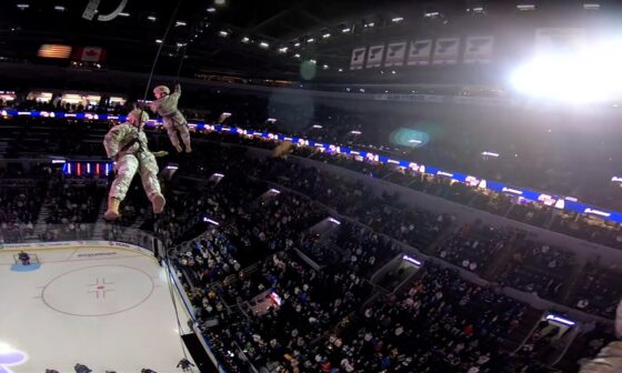 POV: Military member rappels from area rafters to deliver game puck