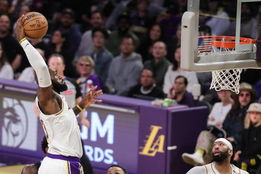 Lakers star LeBron James dunks during a 116-110 win over the Memphis Grizzlies at Crypto.com Arena on Sunday.