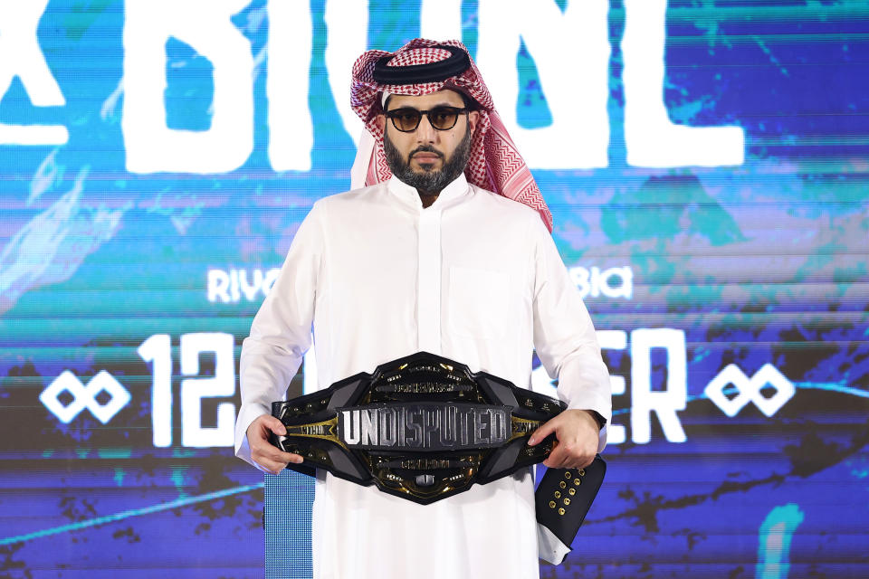 RIYADH, SAUDI ARABIA - OCTOBER 11: Turki Alalshikh, Chairman of the General Entertainment Authority, looks on as he holds the Undisputed belt during the weigh-in as part of the Riyadh Season - IV Crown Showdown at The Venue on October 11, 2024 in Riyadh, Saudi Arabia. (Photo by Richard Pelham/Getty Images)