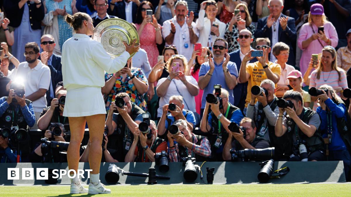 Barbora Krejcikova poses for the crowd with the Wimbledon trophy at this year's championships