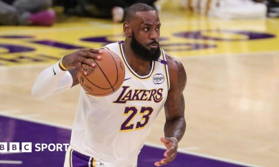 LeBron James holds the basketball in his right hand while playing for the LA Lakers