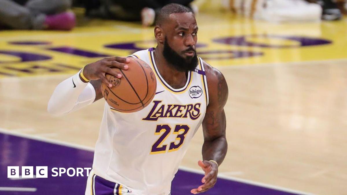 LeBron James holds the basketball in his right hand while playing for the LA Lakers