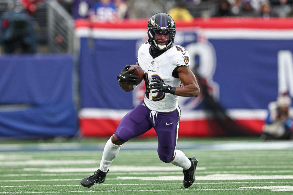 Dec 15, 2024; East Rutherford, New Jersey, USA; Baltimore Ravens running back Justice Hill (43) carries the ball during the second half against the New York Giants at MetLife Stadium. Mandatory Credit: Vincent Carchietta-Imagn Images