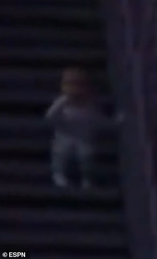 The baby is seen on the steps