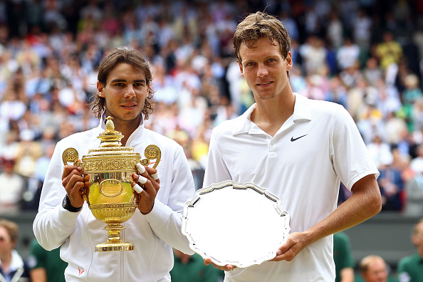 Rafael Nadal of Spain holds the Championship trophy after winning the Men's Singles Final match against Tomas Berdych of Czech Republic (R) on Day ...