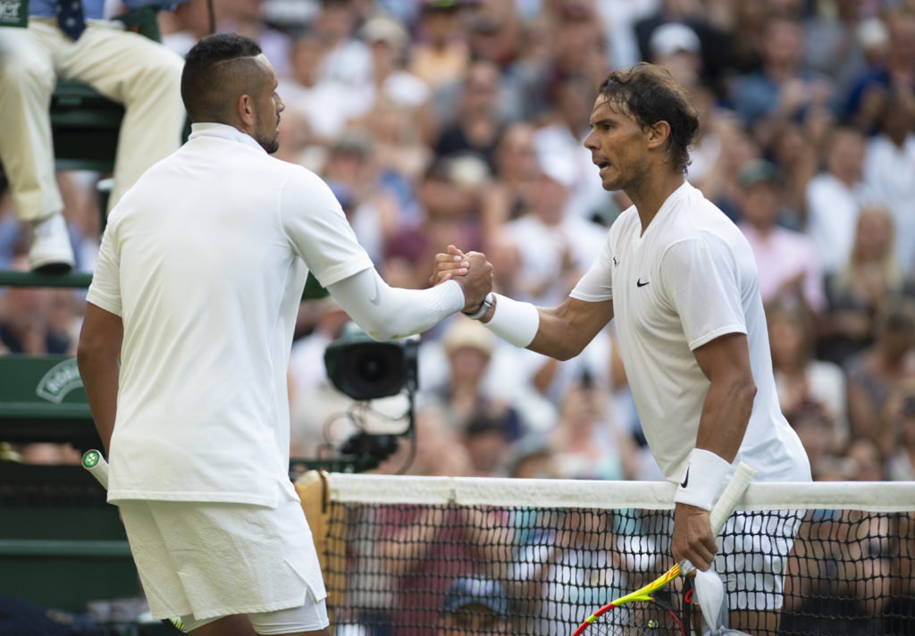 Rafael Nadal of Spain shakes hands with Nick Kyrgios of Australia during Day Four of The Championships - Wimbledon 2019 at All England Lawn Tennis ...