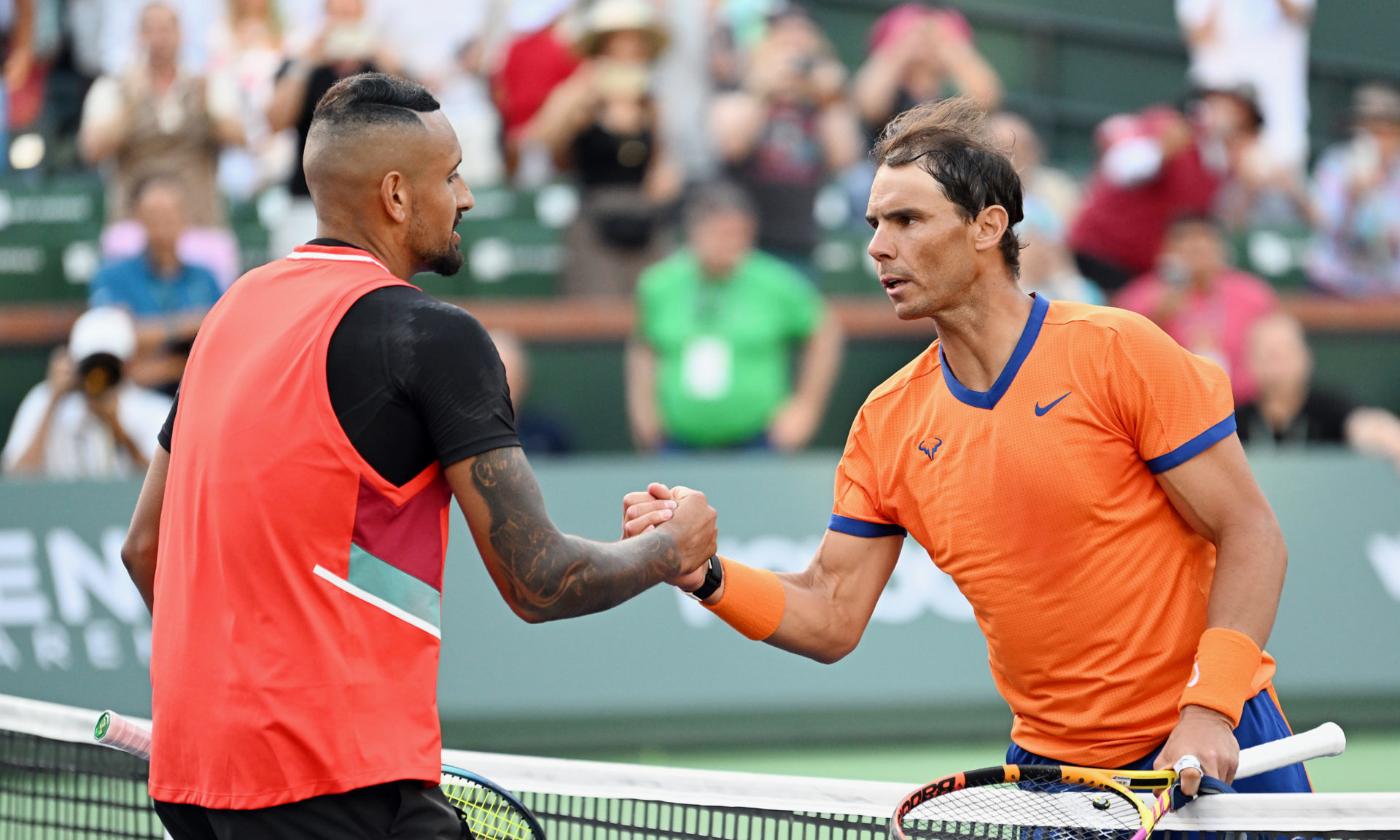 Rafael Nadal of Spain shacks hands with Nick Kyrgios of Australia after Nadal defeated Kyrgios in three sets in a quarterfinals tennis match played...