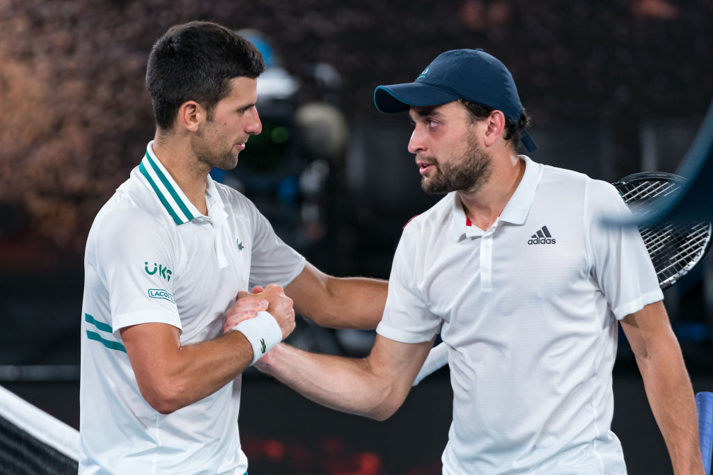 Novak Djokovic of Serbia shakes hands with Aslan Karatsev of Russia following Djokovic's victory in their Men’s Singles Semifinals match during day...