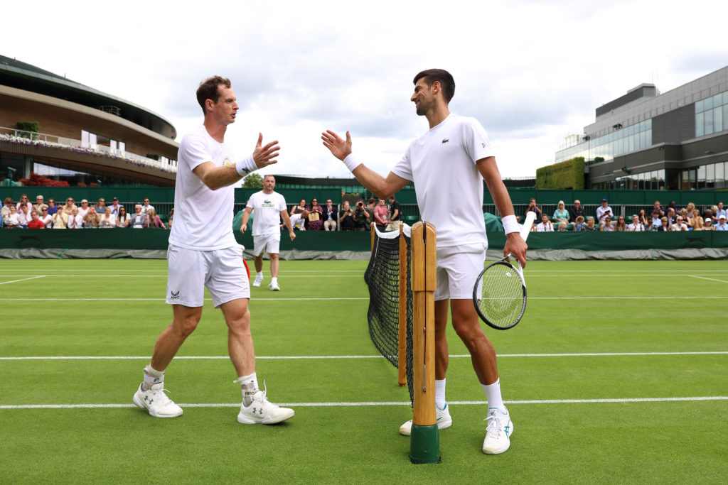 Andy Murray of Great Britain and Novak Djokovic of Serbia shake hands after a practice session ahead of The Championships - Wimbledon 2023 at All E...