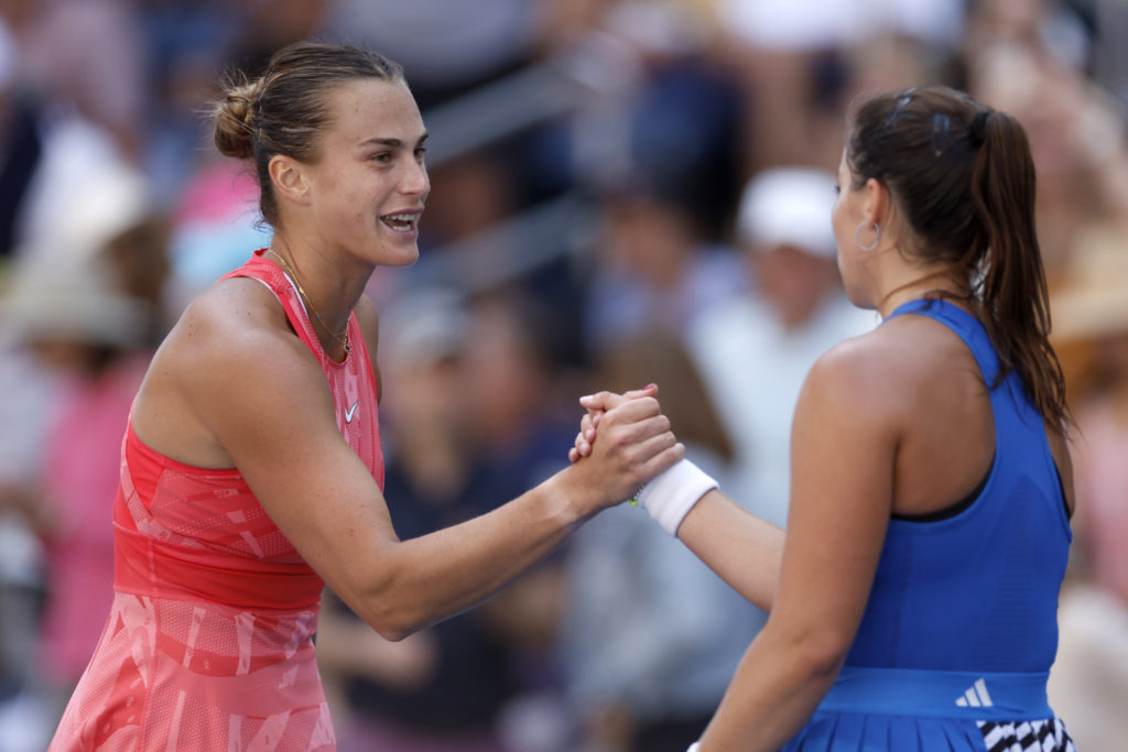 Aryna Sabalenka(L) of Belarus shakes hands after a win against Jodie Burrage of Great Britain during their Women/Men's Singles Second Round match o...