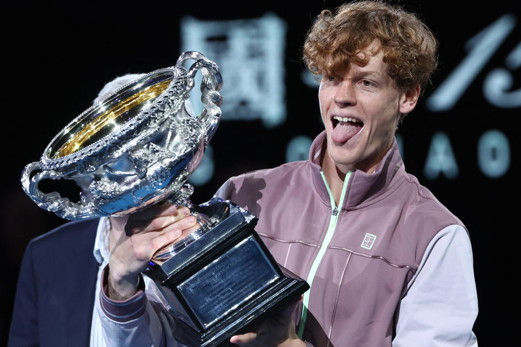 TOPSHOT - Italy's Jannik Sinner celebrates with the Norman Brookes Challenge Cup trophy after defeating Russia's Daniil Medvedev in the men's singl...