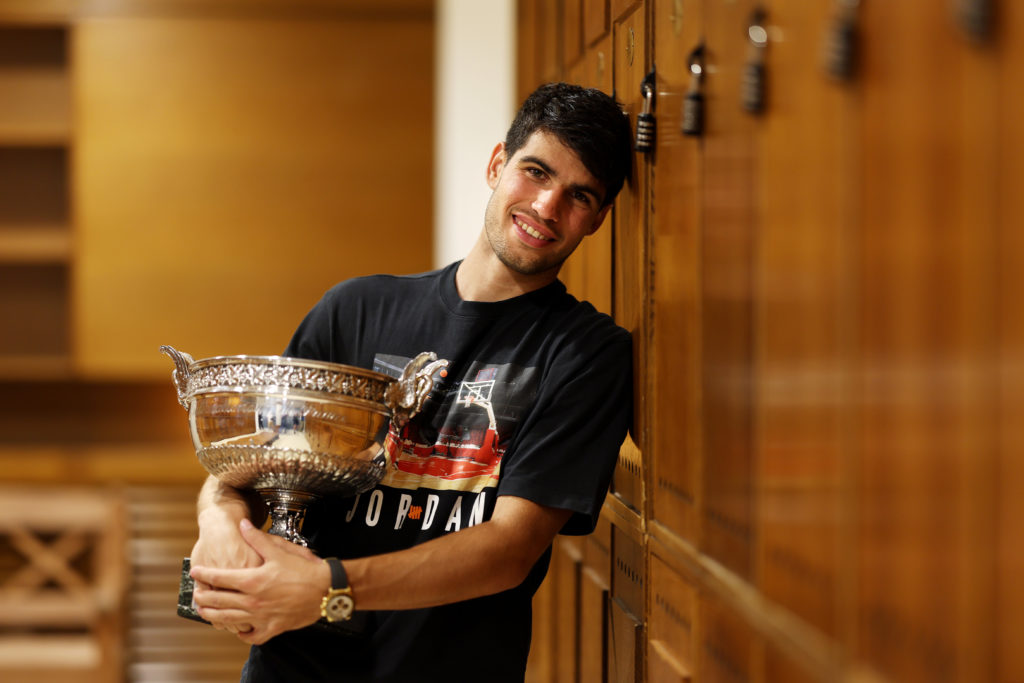 Carlos Alcaraz of Spain poses for a photo with the trophy inside the locker room after victory in the Men's Singles Final match Alexander Zverev of...