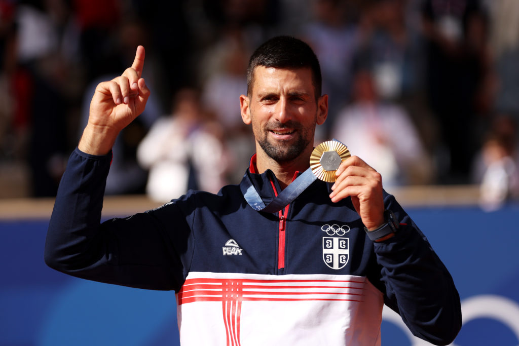 Gold medalist Novak Djokovic of Team Serbia celebrates on the podium during the Tennis Men's Singles medal ceremony after the Tennis Men's Singles ...