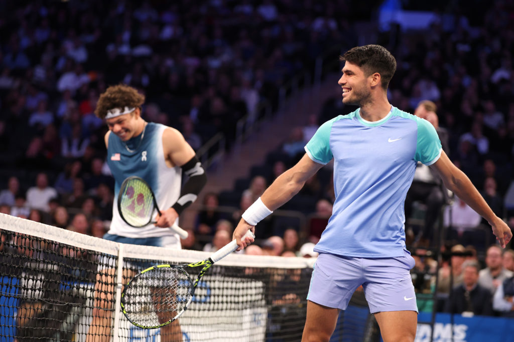 Carlos Alcaraz of Spain (R) and Ben Shelton of the United States of America laugh between points during their exhibition match during the Garden Cu...