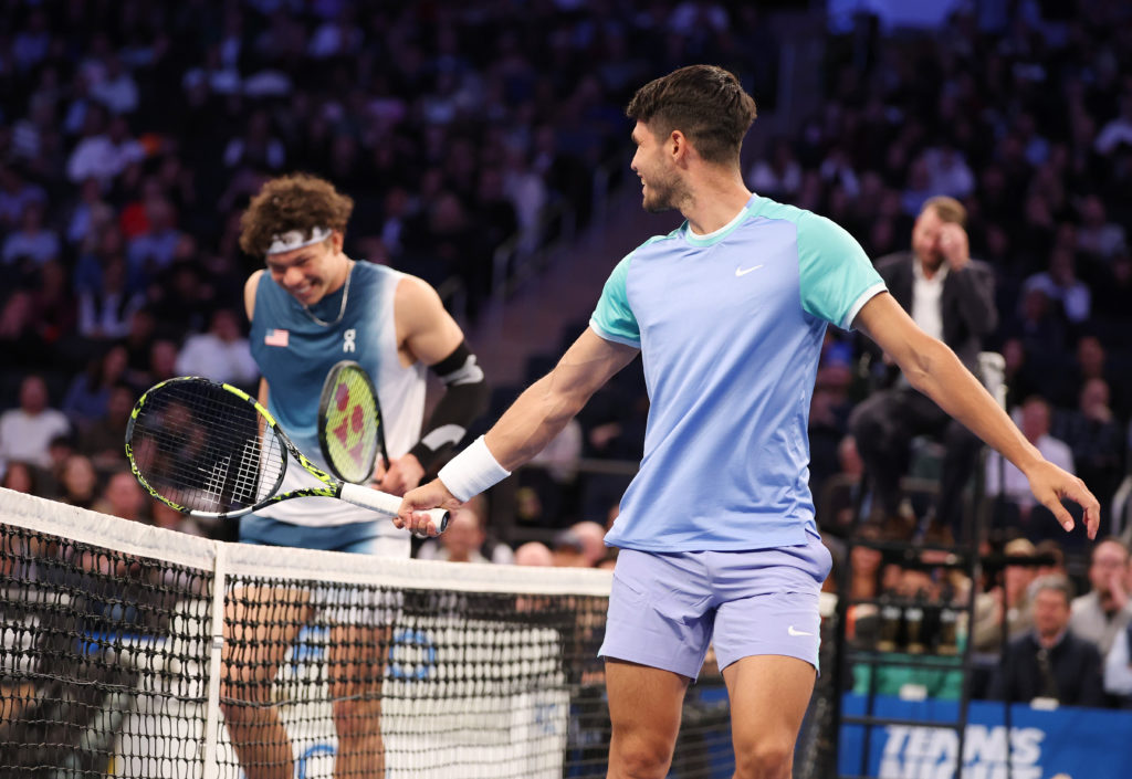 Carlos Alcaraz of Spain (R) and Ben Shelton of the United States of America laugh between point during their exhibition match during the Garden Cup...