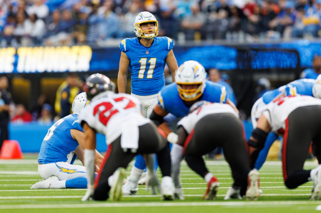 Place kicker Cameron Dicker #11 of the Los Angeles Chargers prepares to kick a field goal during an NFL football game against the Tampa Bay Buccaneers, at SoFi Stadium on December 15, 2024 in Inglewood, California. 