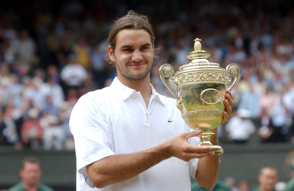 Roger Federer of Switzerland holds the trophy after his victory over Mark Philippoussis of Australia in the Mens Singles Final during the final day...