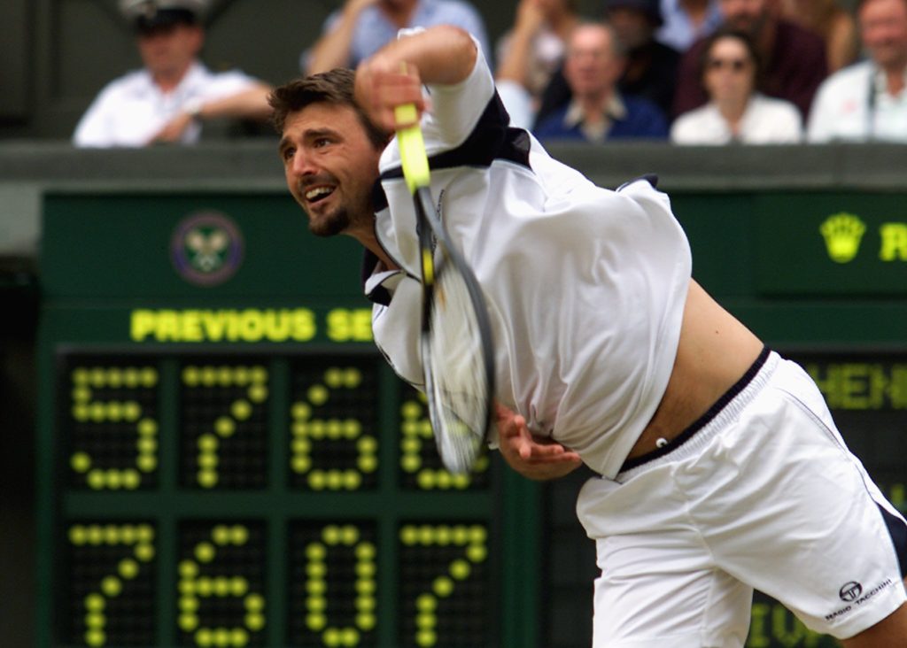 Croatian player Goran Ivanisevic serves during his semi final match against Britain's Tim Henman at the All England Tennis Championships, 08 July 2...