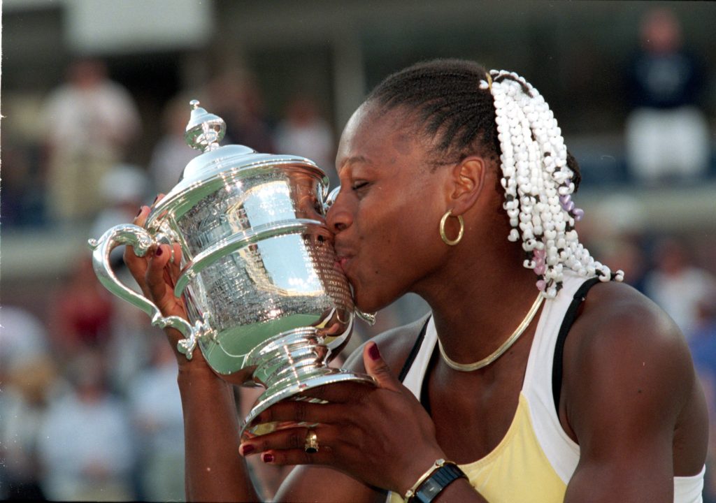 American tennis player Serena Williams kisses her trophy after winning a match (against Martina Hingis of Switzerland) during the US Open at the US...