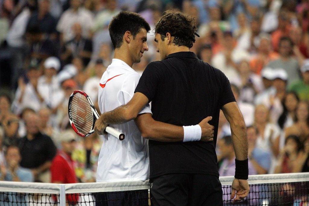 Roger Federer of Switzerland greets Novak Djokovic of Serbia after defeating him by a score of 7-6(4), 7-6(2), 6-4 to win the Men's Singles Final o...