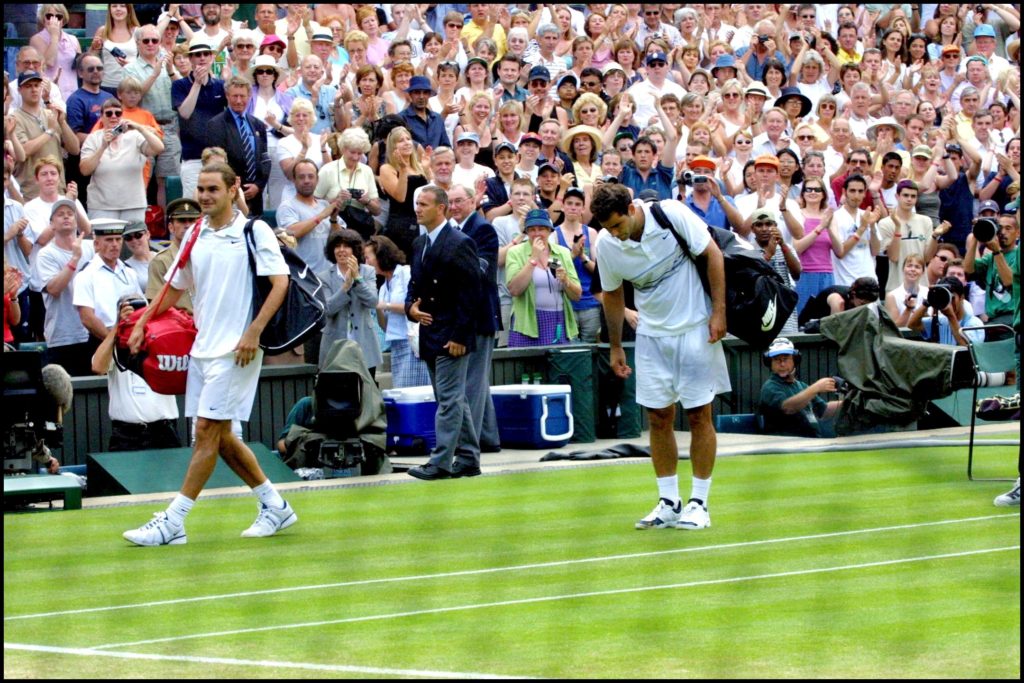 Federer smiles, as a defeated Pete Sampras bows to the royal box. Federer bowed before leaving the center court.