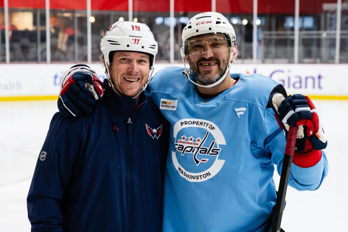 Nicklas Backstrom assists Alex Ovechkin on the ice as he recovers from fractured fibula