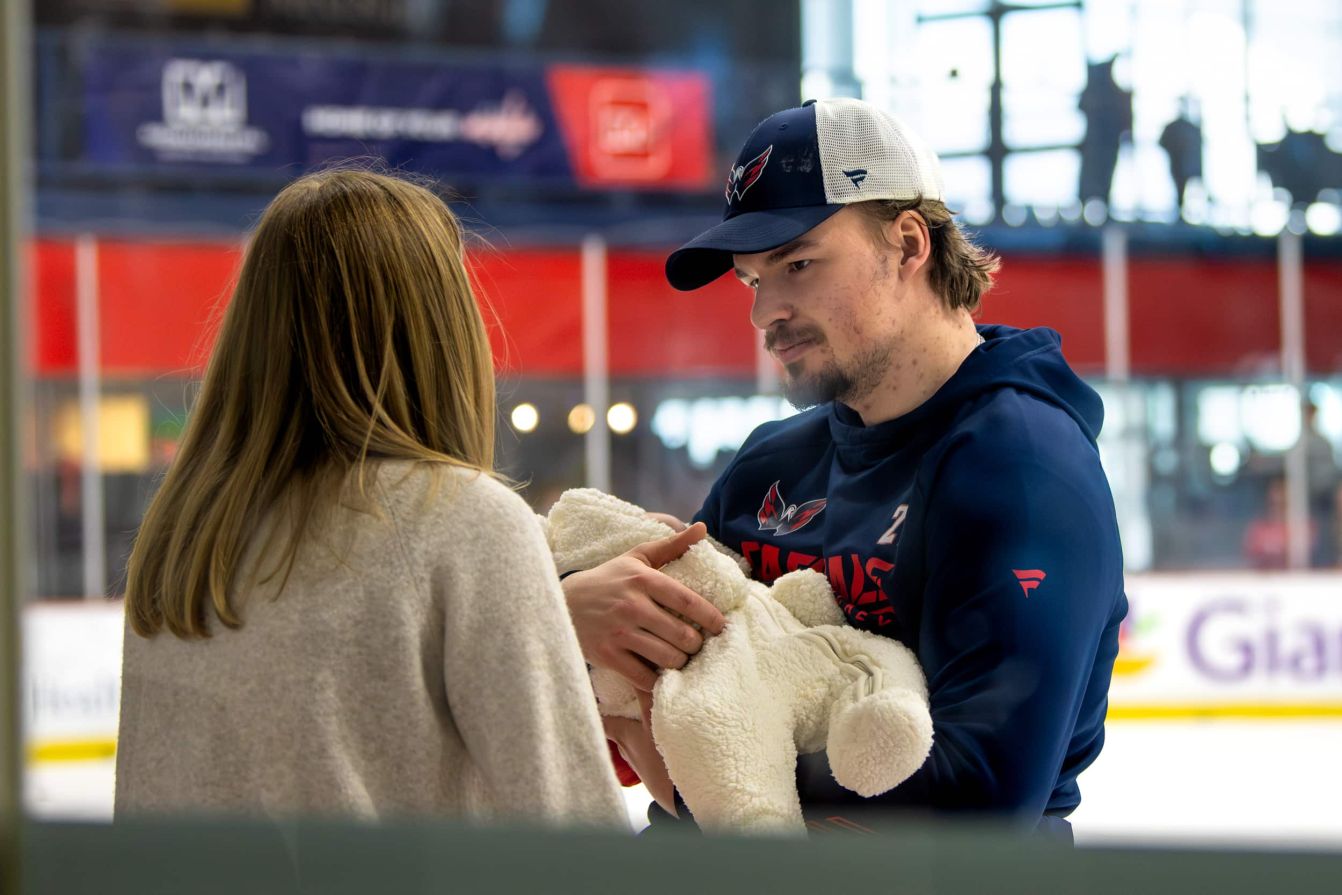 Alex Alexeyev holds his son Ivan while speaking to his wife Kate Alexeyeva