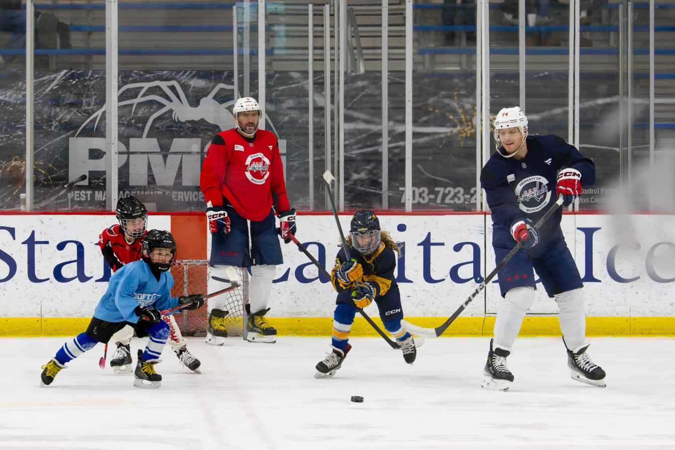 Alex Ovechkin and John Carlson play hockey with Ilya Ovechkin, Vivian Carbery, and Lucca Carlson