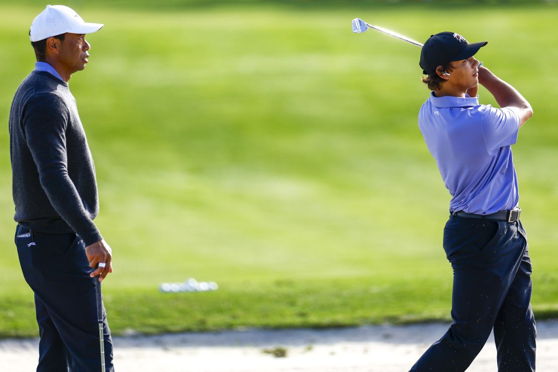 Tiger Woods and son Charlie Woods warm up on Friday ahead of the PNC Championship.