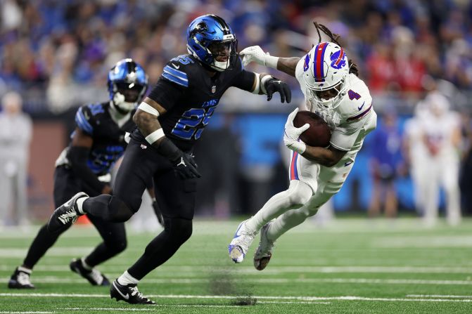 Buffalo Bills running back James Cook runs with the ball while being chased by Detroit Lions safety Jamal Adams in the third quarter of the Bills' 48-42 win at Ford Field in Detroit on December 15.